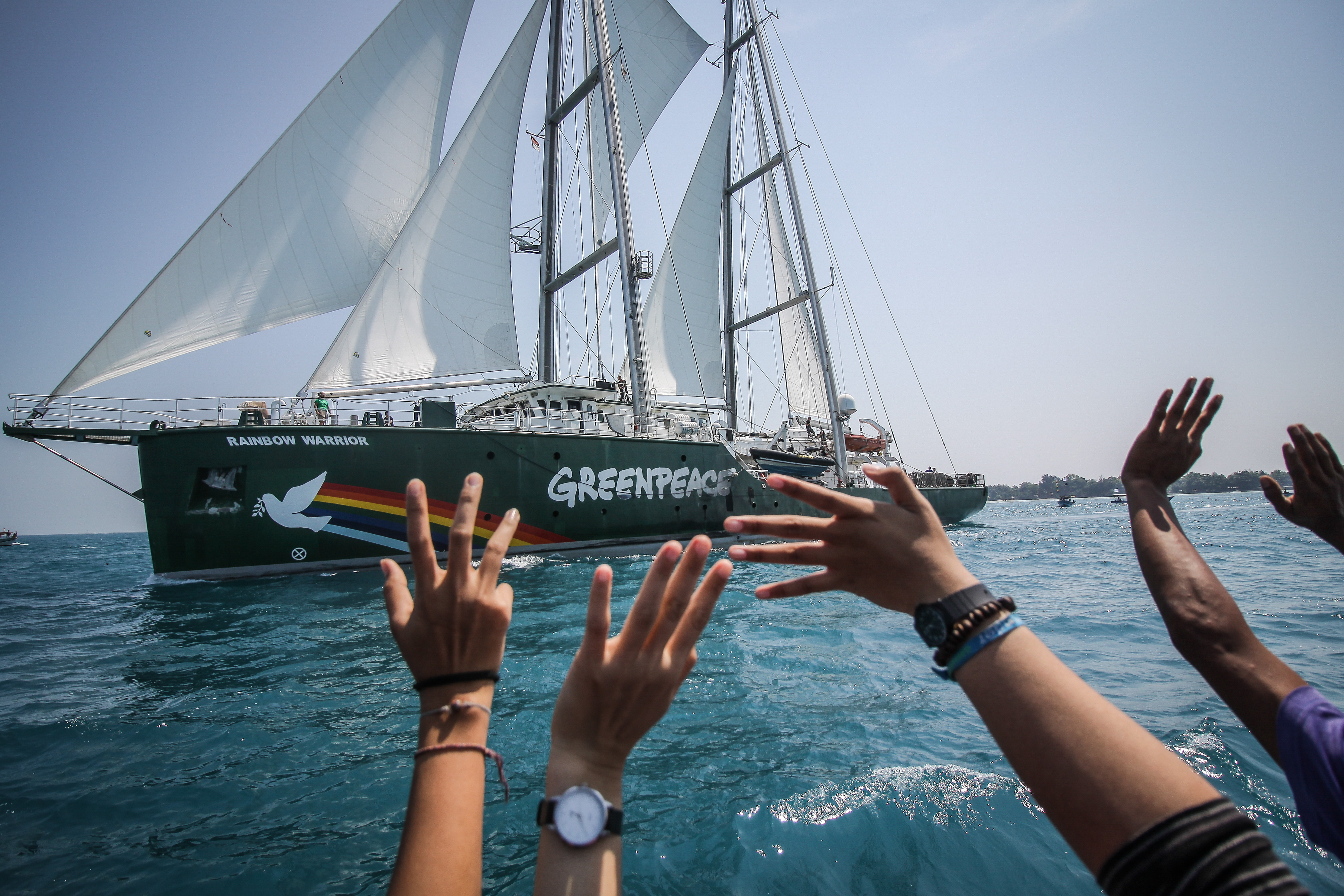 Greenpeace Rainbow Warrior ship joins with dozens of fishermen boats of Pari island as they hold an action to save Pari island in Thousands Islands, North Jakarta.